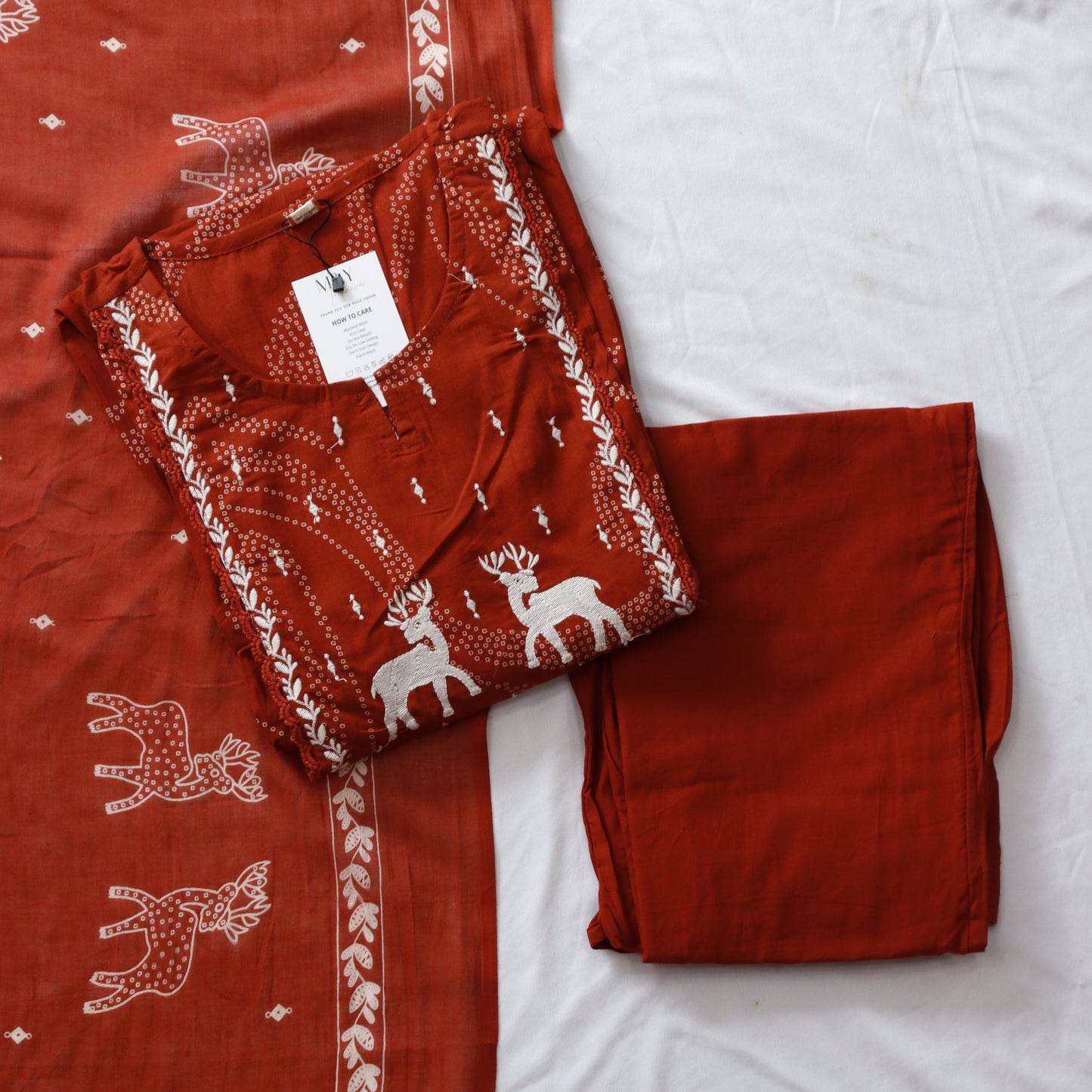 Red fabric with white deer pattern on a white background