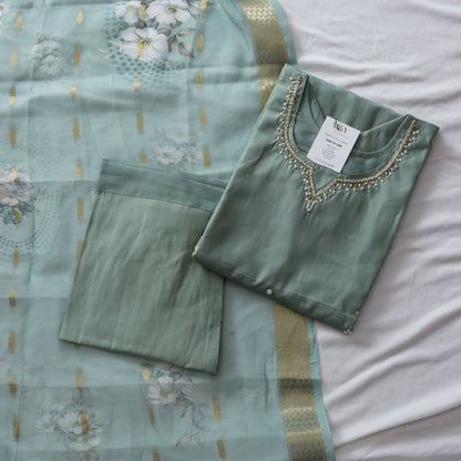 Green suit set with floral patterns on a white background