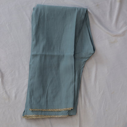 Teal embroidered fabric with a peacock design