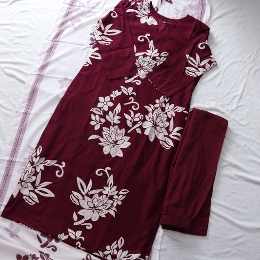 Maroon garment with white floral patterns on a white background